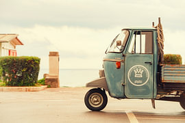 A vintage Piaggio Ape on the Tuscan coast in Italy. by Ron van der Stappen
