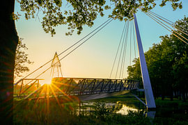 De Slinger cycle bridge in Drachten, featuring a sunburst and flare by R Smallenbroek