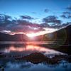 le dernier rayon de soleil de la journée sur le lac sans vent en Écosse sur Hans de Waay
