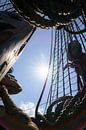 Mast and ropes of old wooden VOC sailing ship against sunlight by Fotografiecor .nl thumbnail