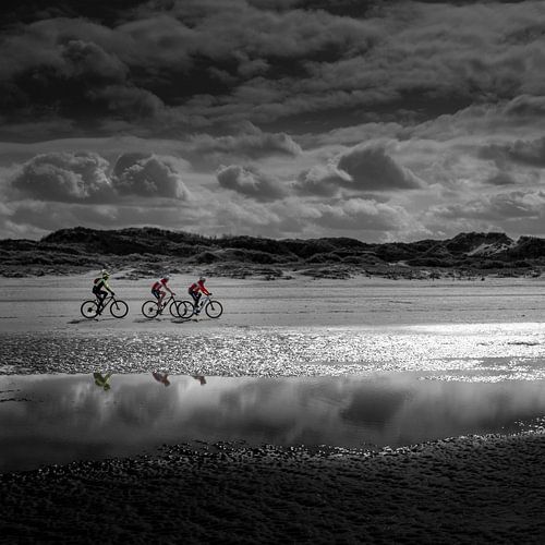 Three cyclists on the beach