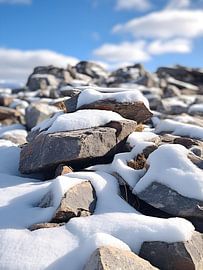 Snow-covered rocks against an alpine backdrop by drdigitaldesign