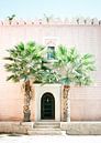 Medina of Marrakech Magic Morocco Pink building with palm trees in front of it by Raisa Zwart thumbnail