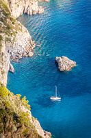 Sailing boat in blue bay on Capri