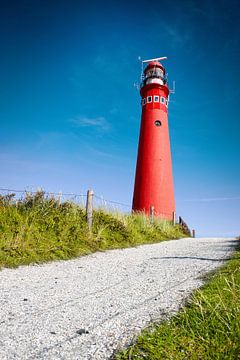 Rode vuurtoren Schiermonnikoog en diep blauwe lucht van Jan Brons