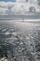Sun over the Wadden Sea with sailing boat