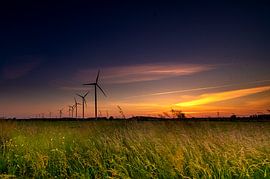 Windmills with a sunset in a Dutch landscape