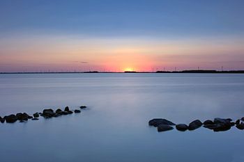 stones in  the water at sunset