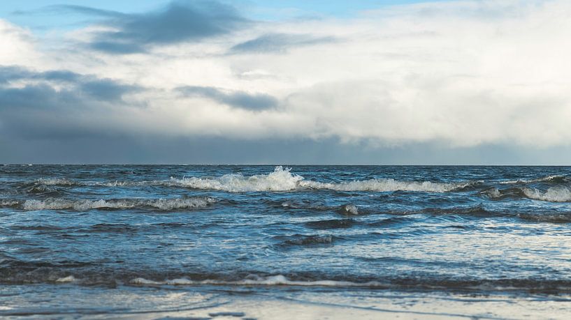 the sea with waves in the surf with the horizon and a cloudy sky in the background by ChrisWillemsen