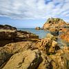 Warm colored granite rocks on the French coast by Karla Leeftink
