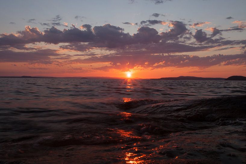 bright orange sunset over the waves scandinavia, karelia by Michael Semenov