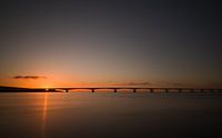 Zeelandbrug bij ondergaande zon van Jan Jongejan thumbnail
