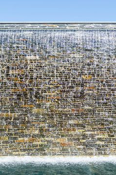 Urban waterfall on a stone wall