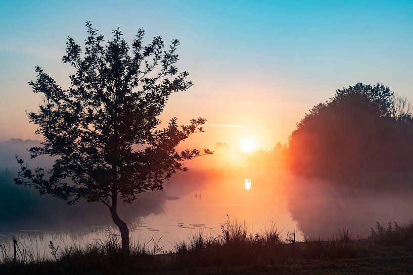Sunrise over the water with fog. by Els Oomis