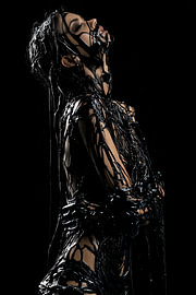 Woman posing in black oil by Jan Bechtum