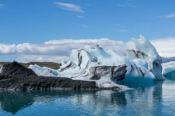 Iceland - Blue and black ice floes on glacier lagoon by adventure-photos