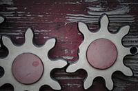 Two wooden gears with a broken tooth