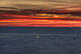 Sunrise and a fishing boat near Lastres, Gulf of Biskaye.
