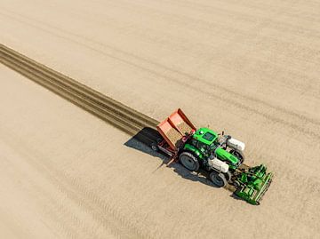 Tractor planting potato seeldings in  the soil during springtime by Sjoerd van der Wal Photography