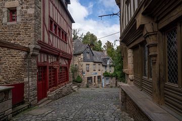 A medieval street in Dinan lined with old buildings by Manuuu