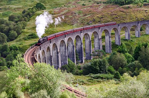 Jacobite steam train on old Glenfinnan viaduct in Scotland