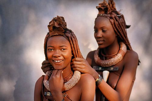 Namibia. Himba tribe. Girls arrange each other's hair.
