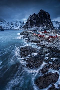 Fishing village in Norway in front of impressive mountain scenery.