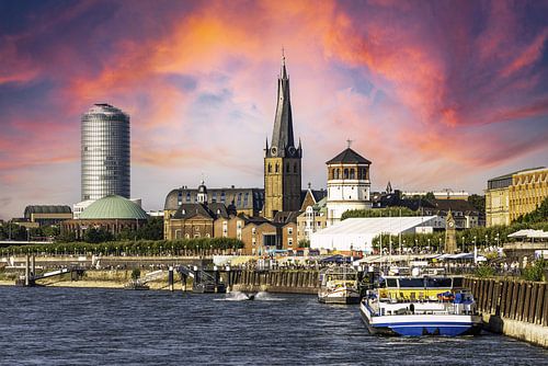 Skyline Rheinuferpromendade in Düsseldorf with old town church and skyscraper and river Rhine