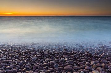 Pebble beach at sunset by Marcel Kerkhof