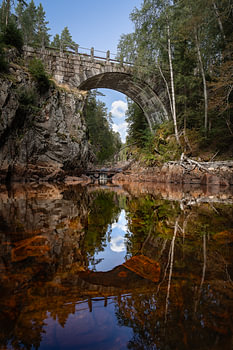 Schwedische Natur – Vertikaler Fotodruck der alten Steinbogenbrücke bei Brattfallet in Värmland
