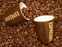coffee beans with two espresso cups