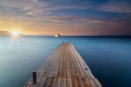 Alter Steg aus Holz am Meer zum Sonnenuntergang