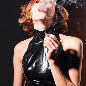 Beautiful woman smokes cigarette by Photostudioholland