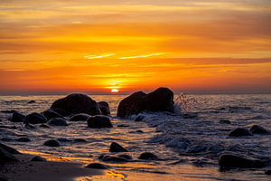 sunset on the beach with rocks on the baltic sea, island Rügen 