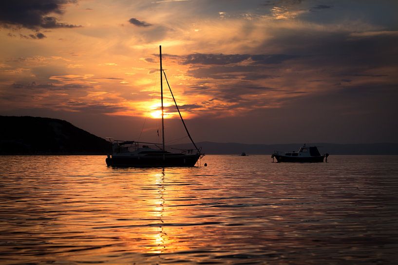 Sunset with sailboat by Yvonne van den Hatert