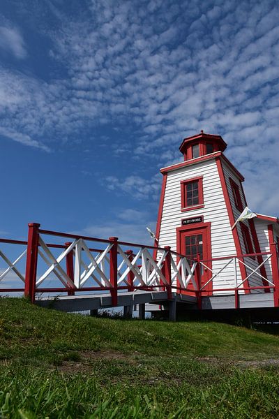 A small lighthouse under a blue sky by Claude Laprise