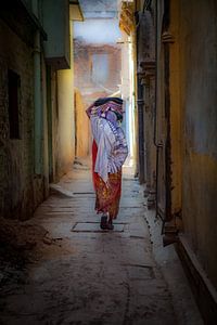 Indian woman in one of the alleys of the city Varanasi Benares in India. Wout Kok One2expose by Wout Kok