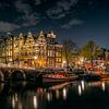 Verlichte grachtenpanden  in Amsterdam op een heldere avond avond, hoek Prinsengracht en Brouwersgra van Roger VDB