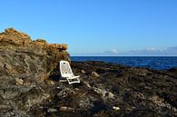 abandoned chair on the rocks of the mediterranean sea by Bella Luna Fotografie thumbnail