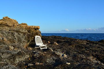 abandoned chair on the rocks of the mediterranean sea by Bella Luna Fotografie