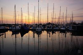 Sailboats in harbour with backlight.