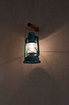 Burning oil lamp by Margot van den Berg
