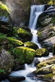 Magical waterfall between green moss covered stones by adventure-photos