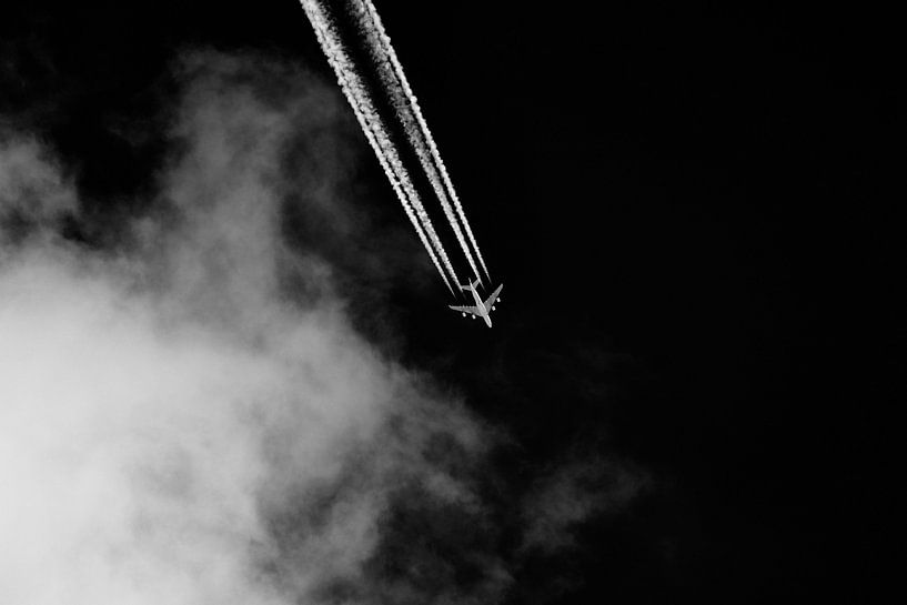 Plane with condensation trails in the sky by Thomas Marx