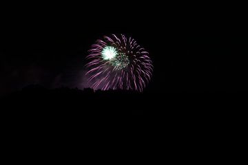 Impressive purple and green fireworks explosion in the night by adventure-photos