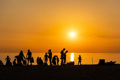 Sunset on the beach, silhouettes.