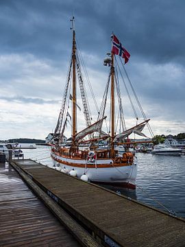 Sailing ship in the harbour of Grimstad in Norway by Rico Ködder