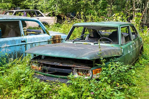 Green Saab 900 car wreck at Bastnas in Sweden