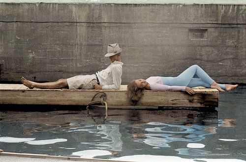 Woman and man lying on a dock, 1940 by Colourful History