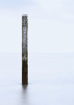 Bollard in the sea